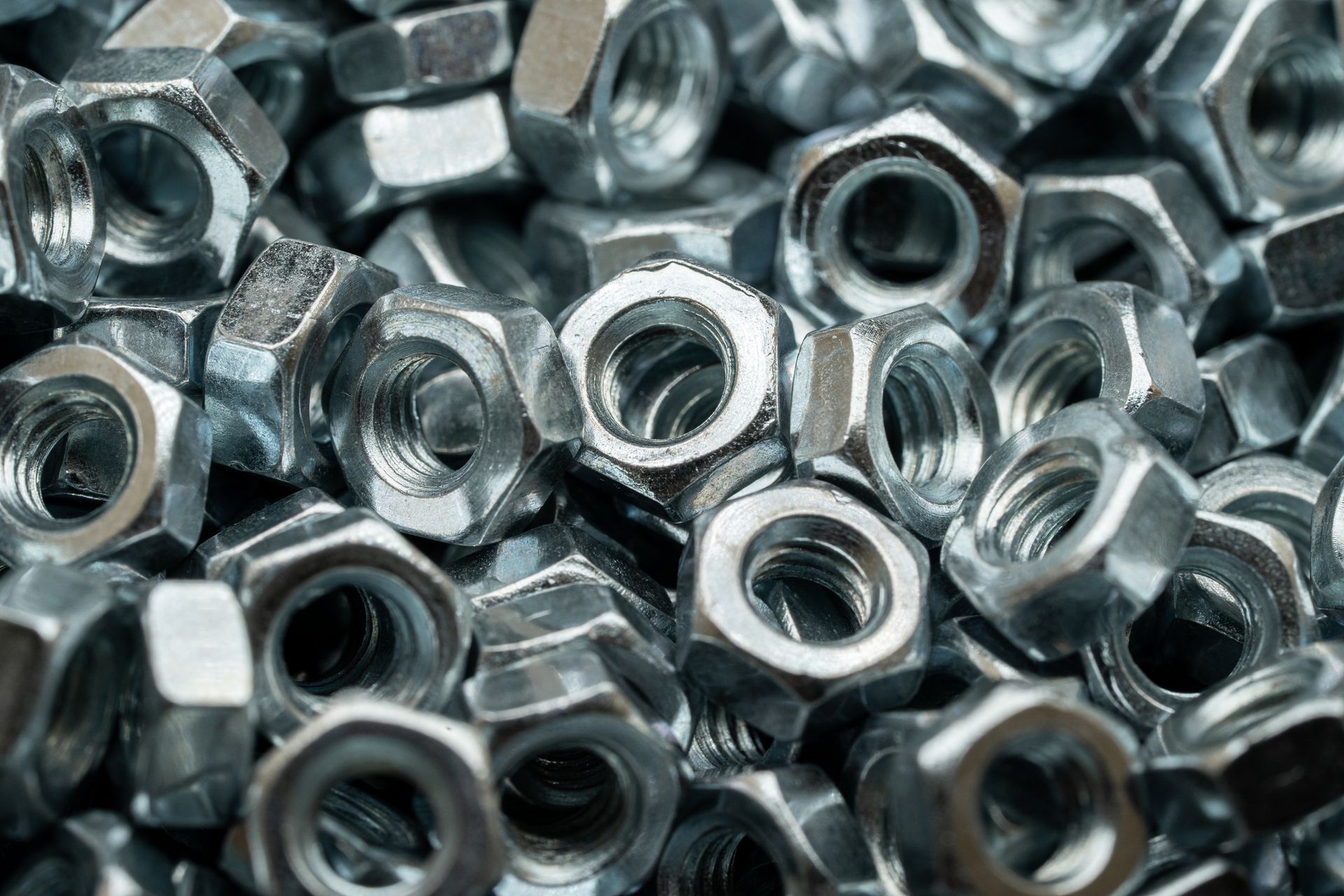 A pile of nuts and bolts are stacked on top of each other.