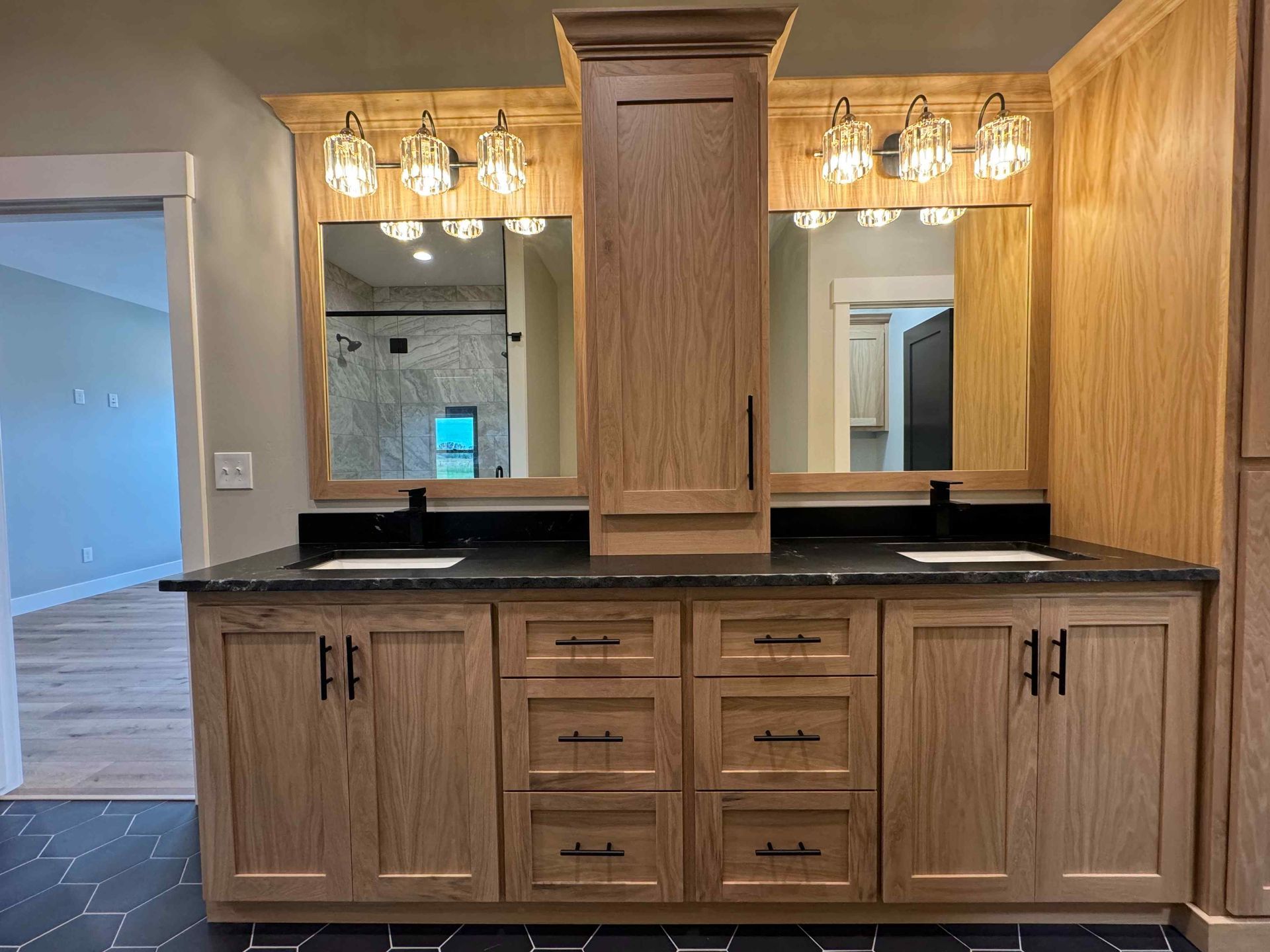 Dining room with wooden table, six chairs, large windows, and a chandelier.