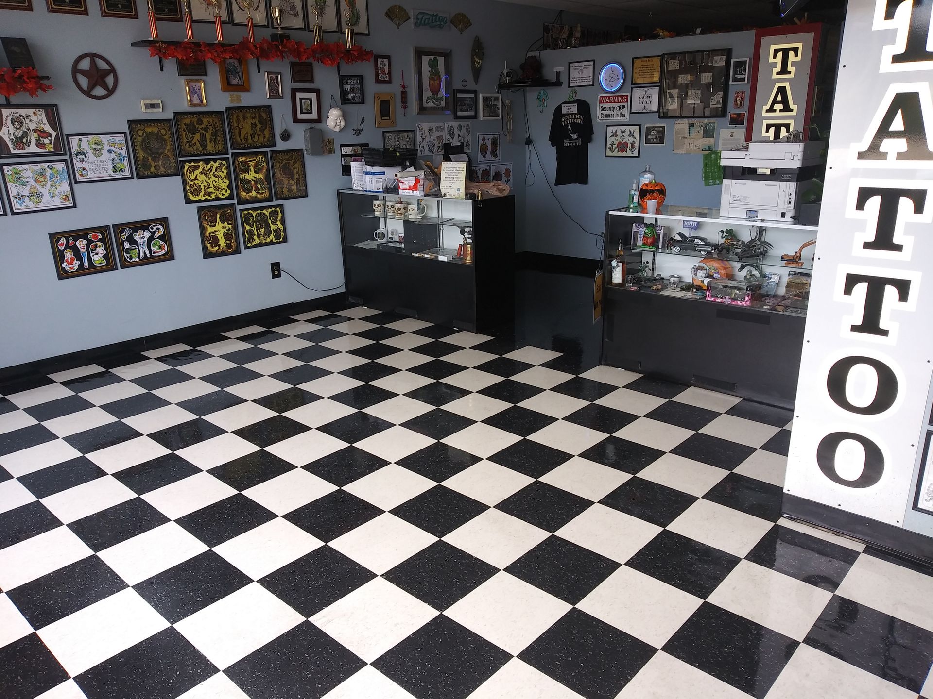 A black and white checkered floor in a tattoo shop