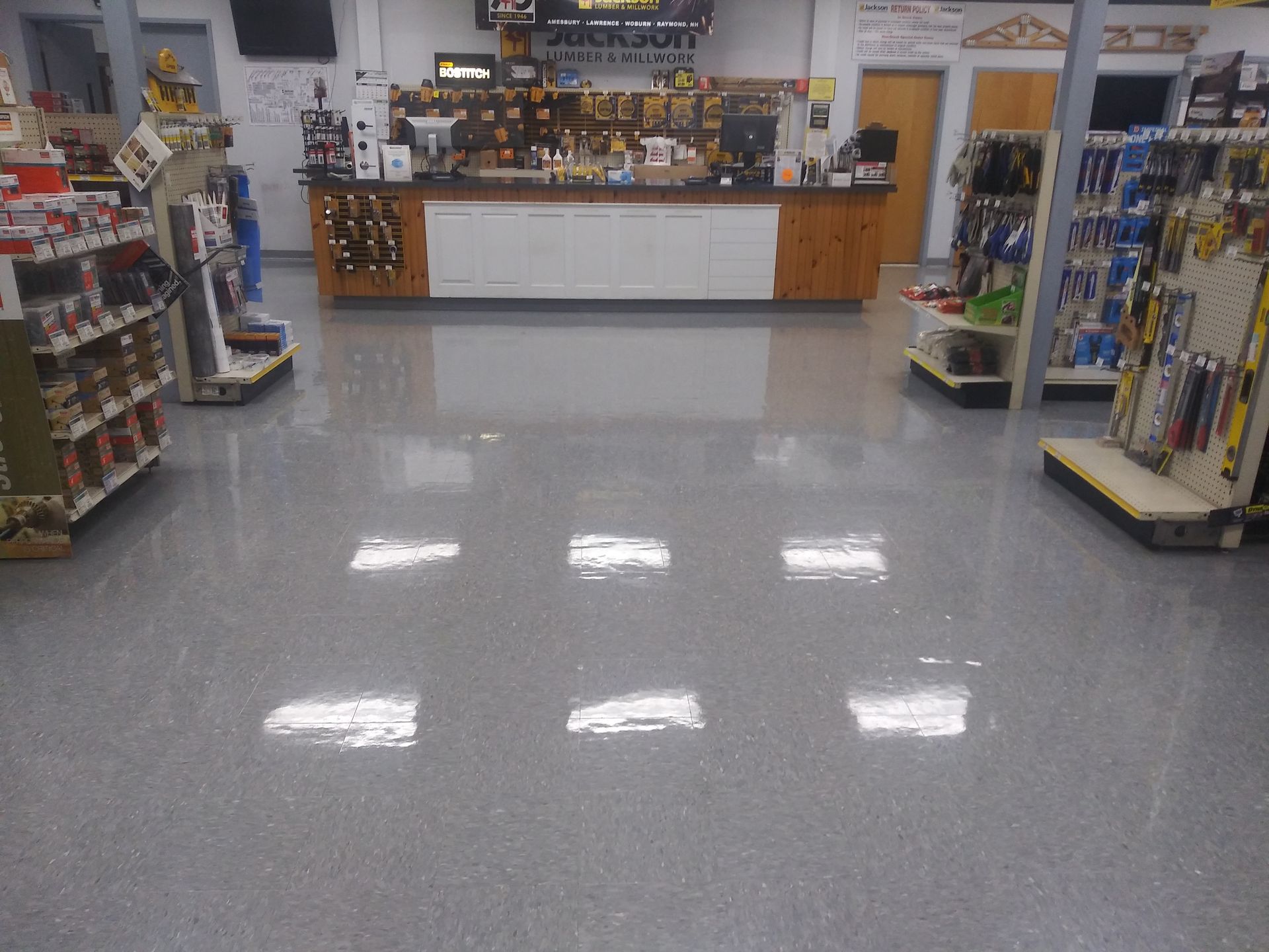 The inside of a hardware store with a counter and shelves