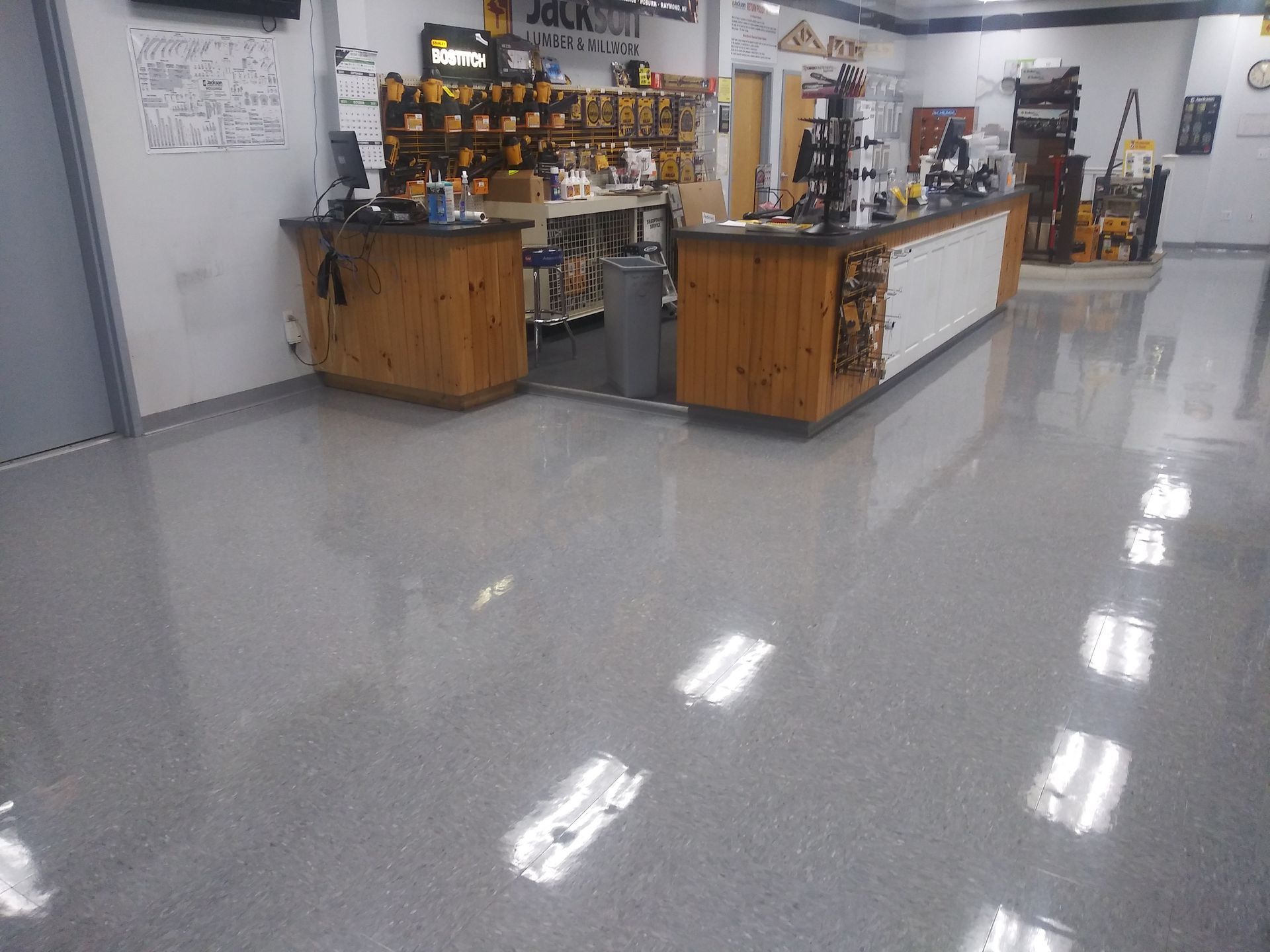 A store with a shiny floor and a wooden counter