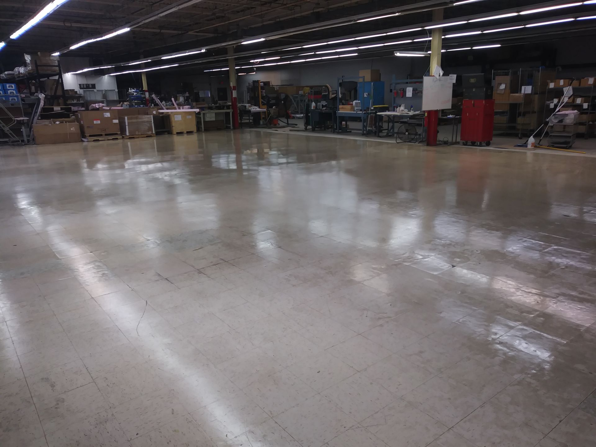 A large warehouse with a shiny concrete floor