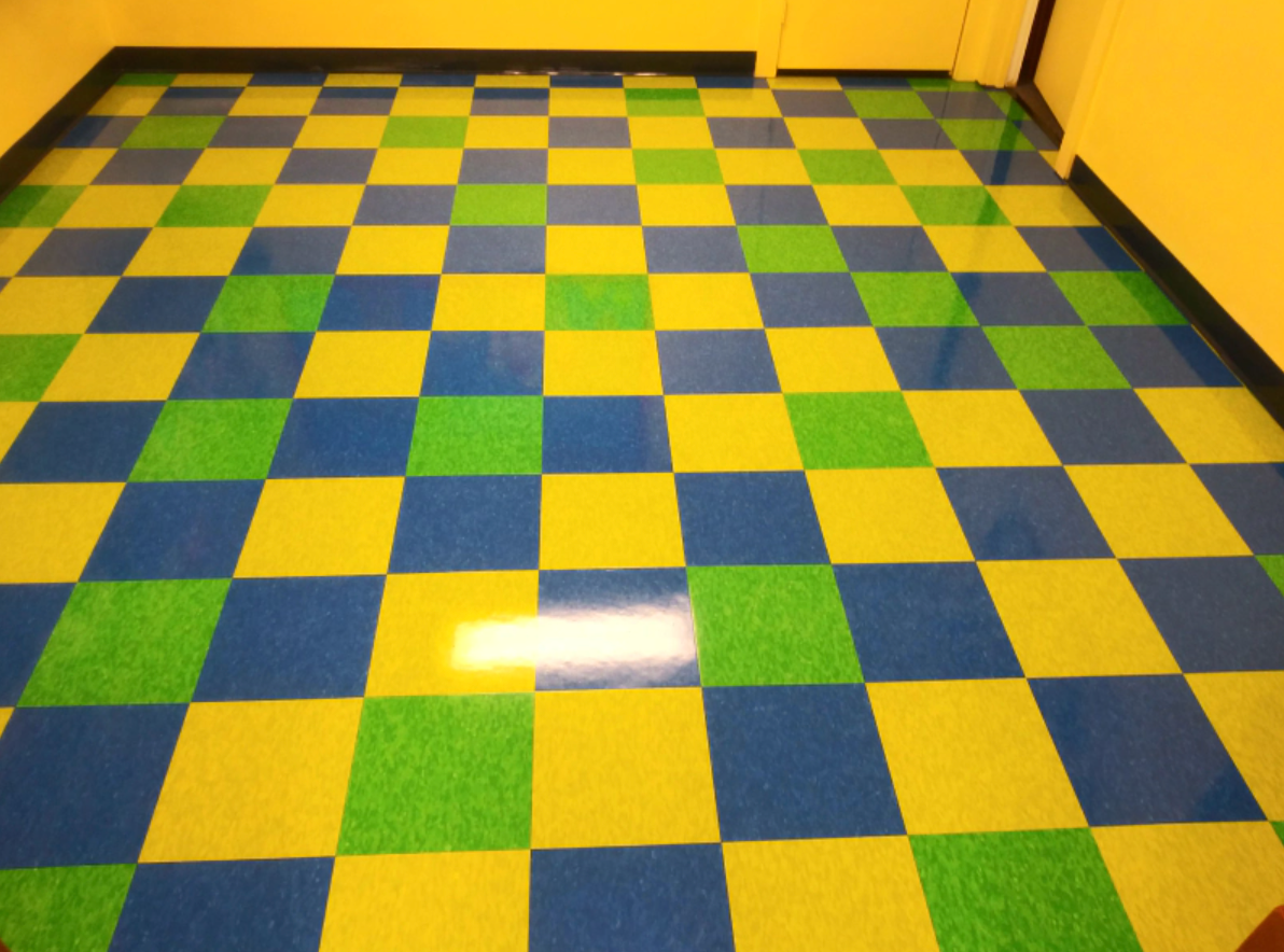 A room with a blue yellow and green checkered floor