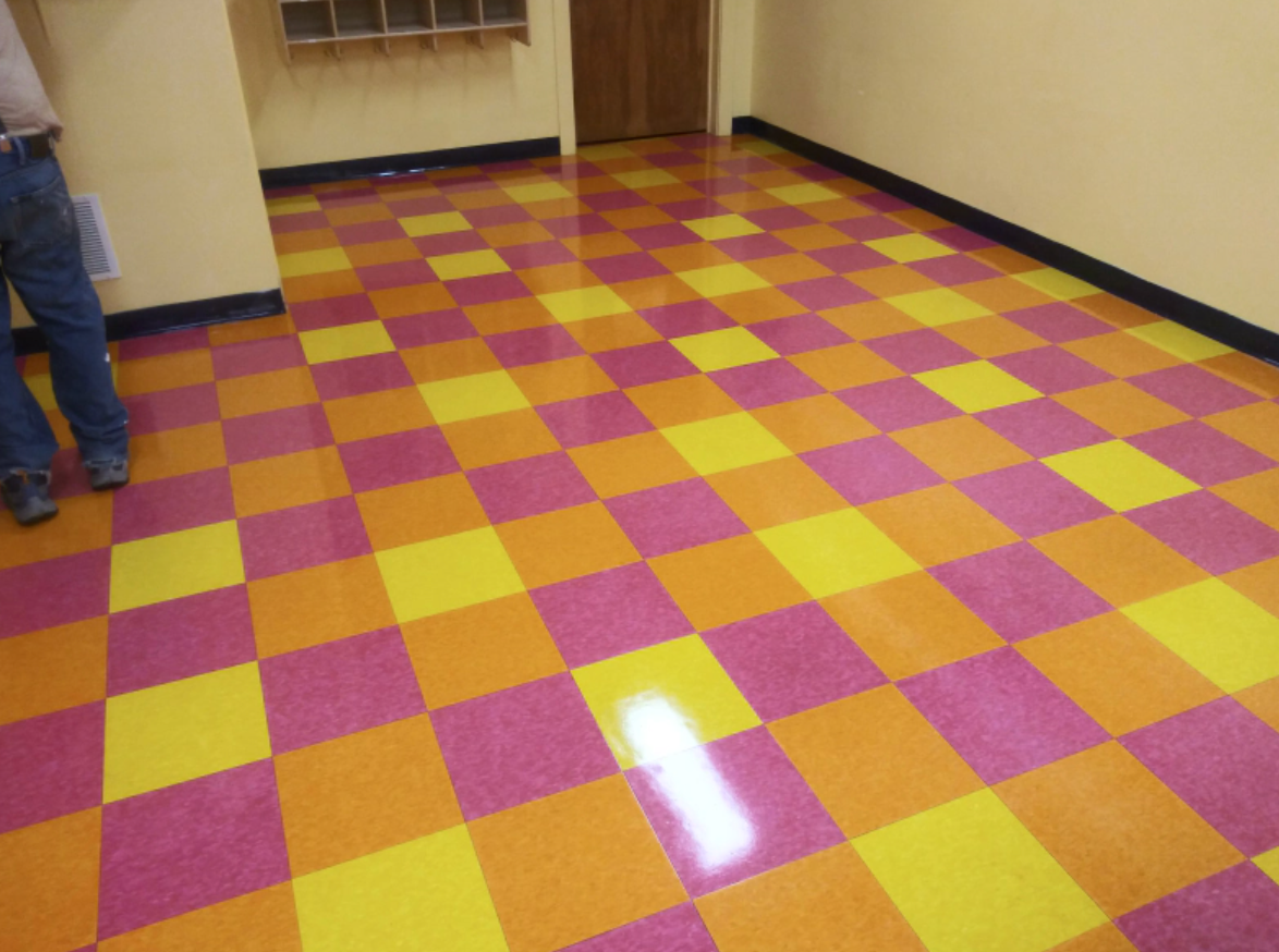 A man standing on a colorful checkered floor