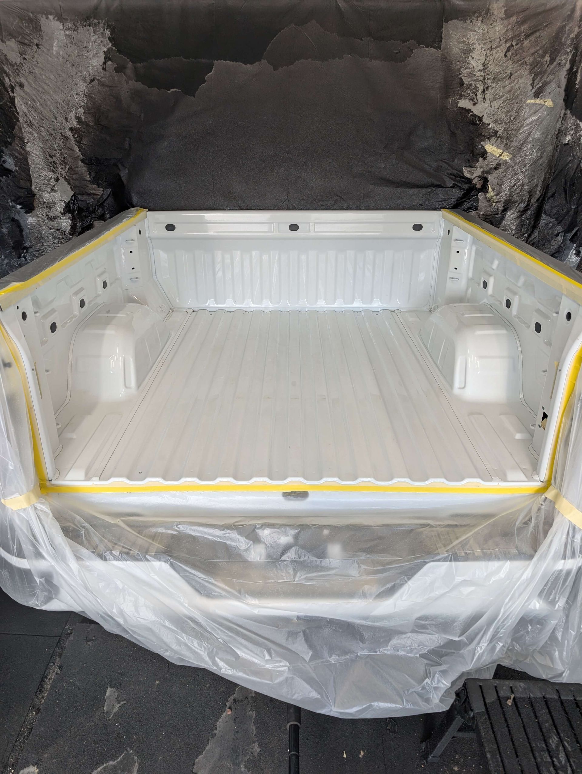 White truck bed masked for paint.