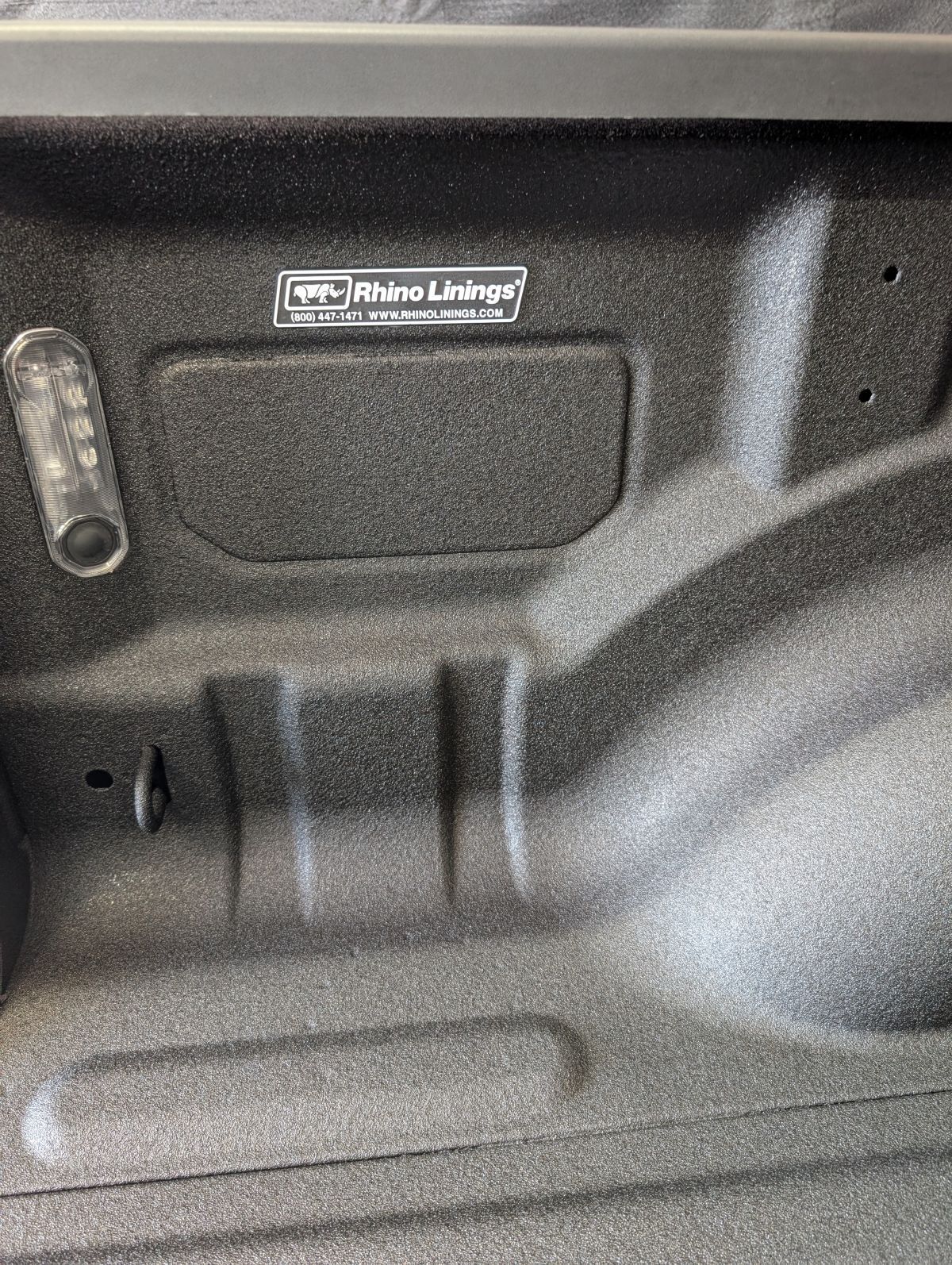Textured black truck bed interior with 