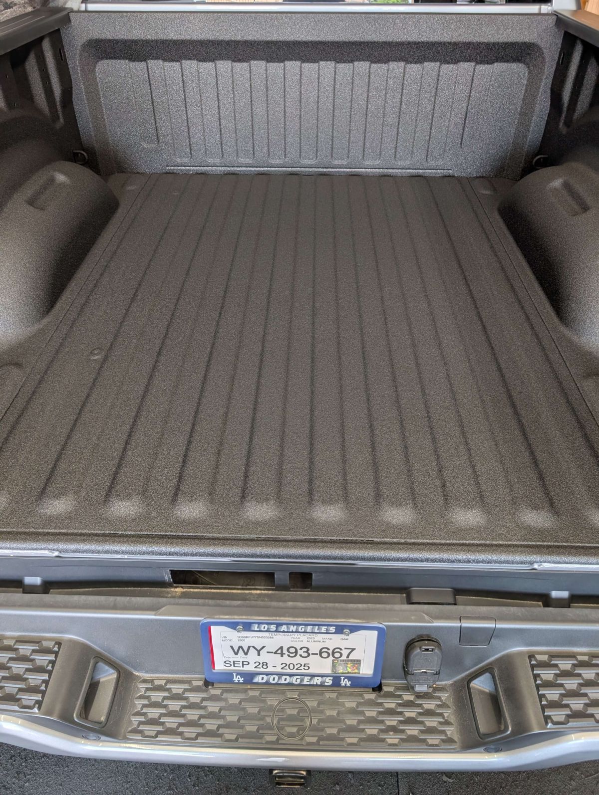 Truck bed with black textured coating, Wyoming license plate.