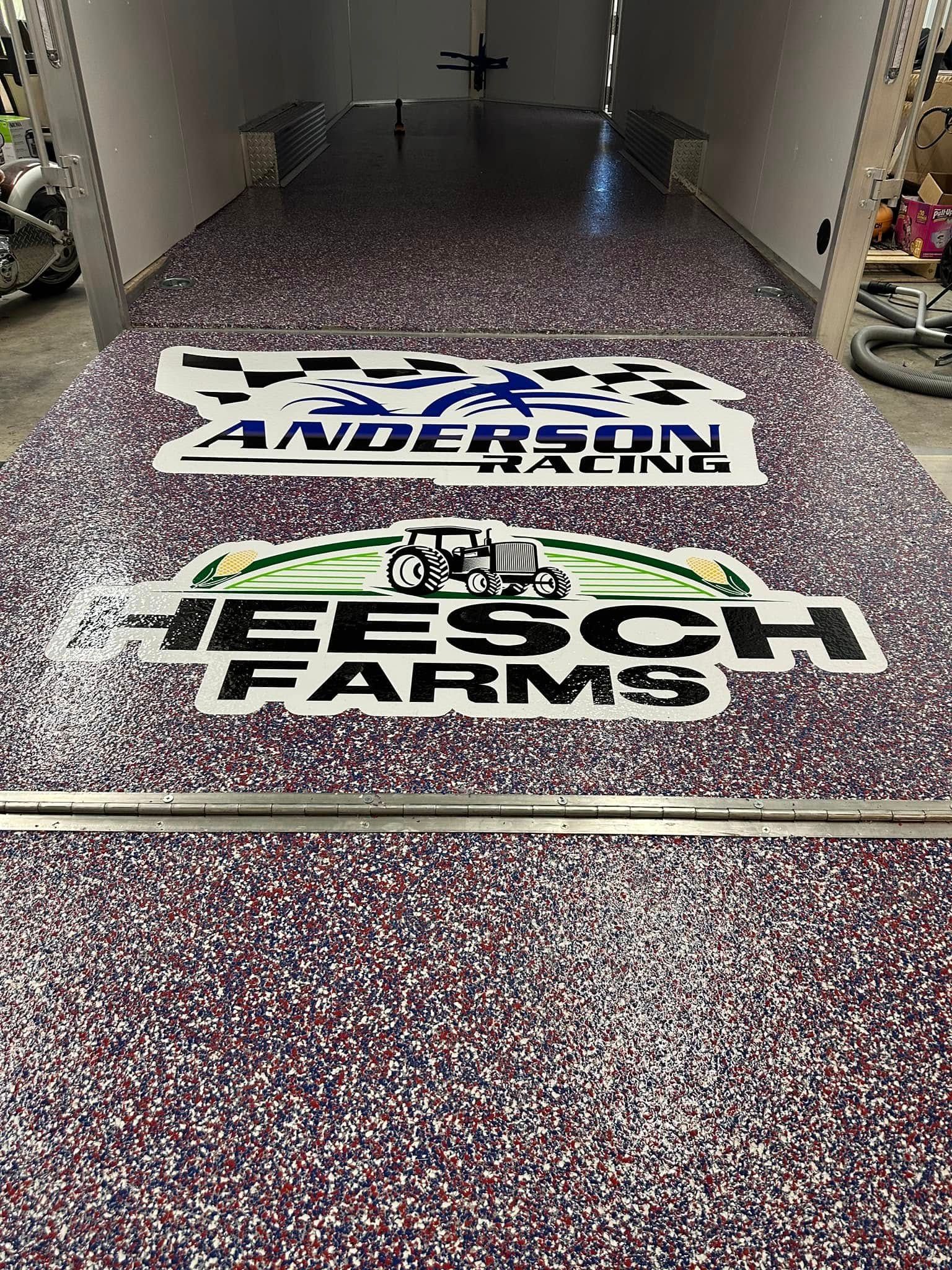 Trailer interior with speckled flooring and logos for Anderson/Hahnk and Heesch Farms.