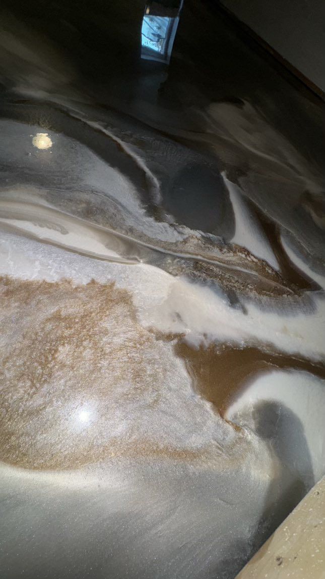 Brown, white, and gray swirled epoxy floor.