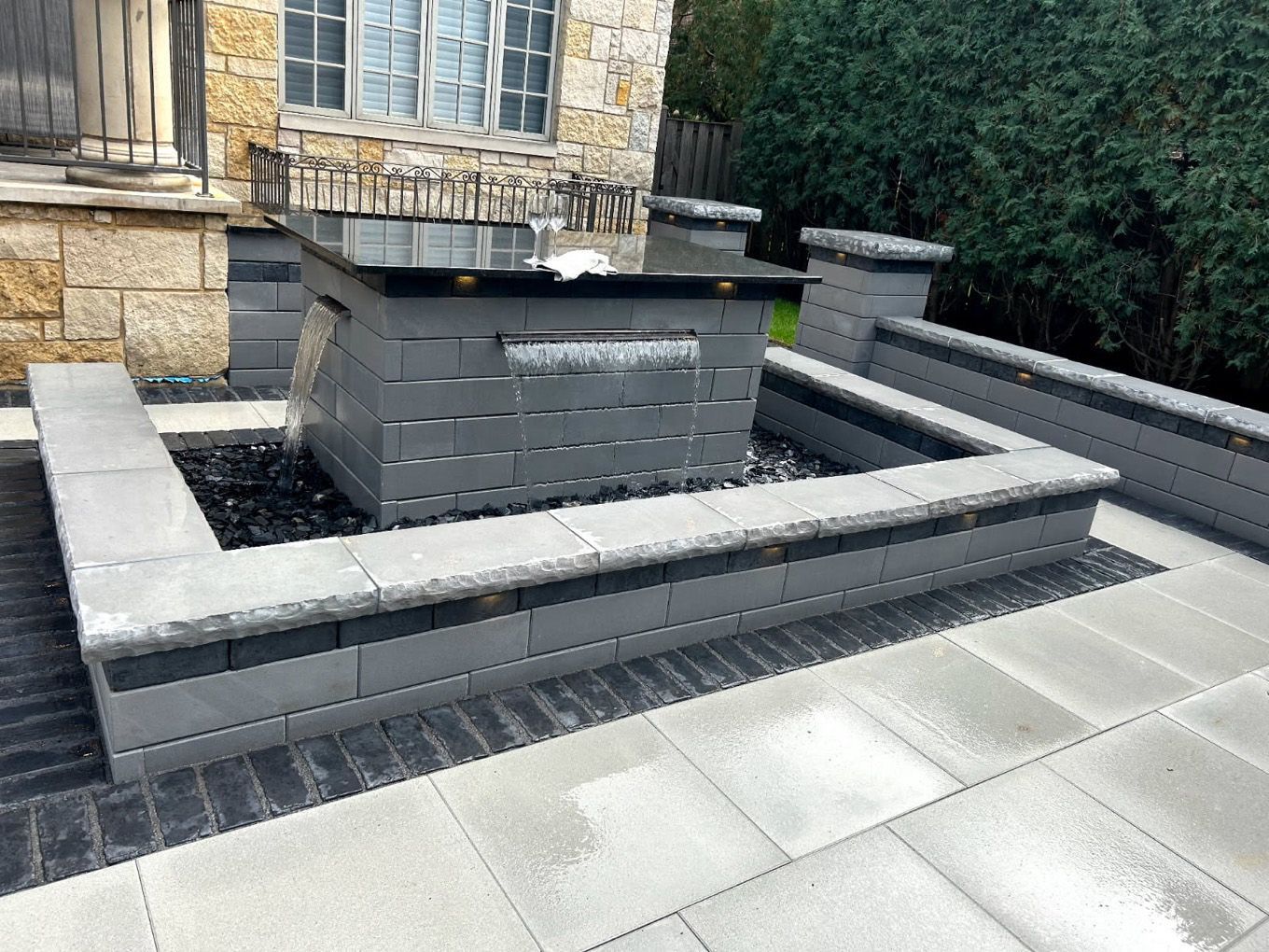 There is a fountain in the middle of the patio.