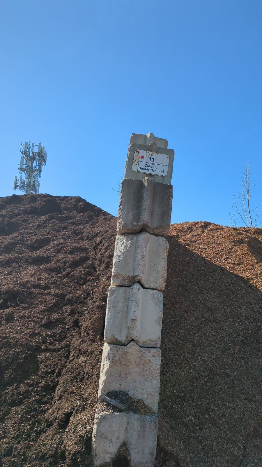 A stack of concrete blocks sitting on top of a pile of dirt.