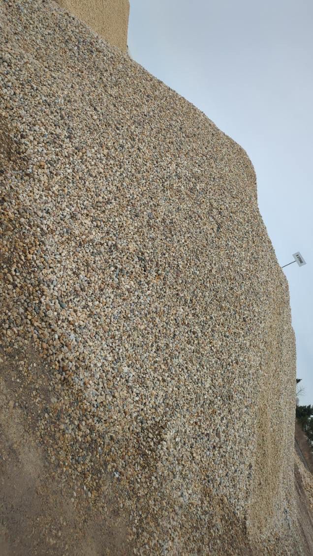 A close up of a rock with a lot of small stones on it.