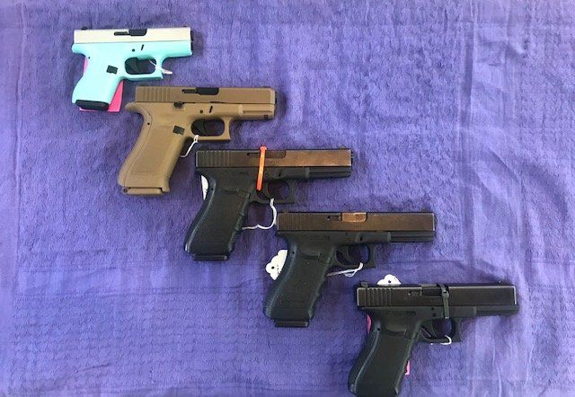 A selection of Glocks, including the Glock 19X and the 43 in blue