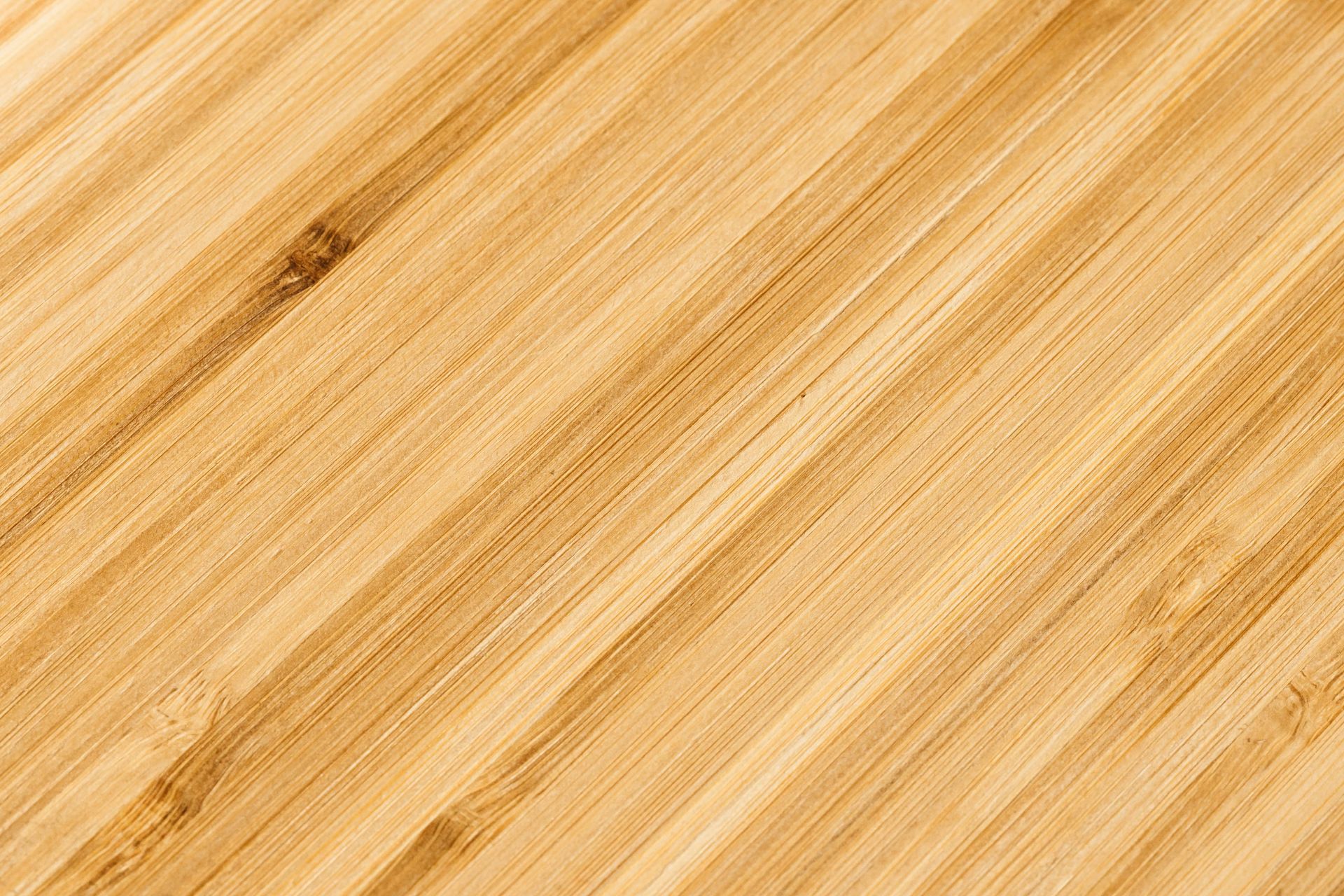 Diagonal close-up of light brown bamboo wood, an eco-friendly floor material
