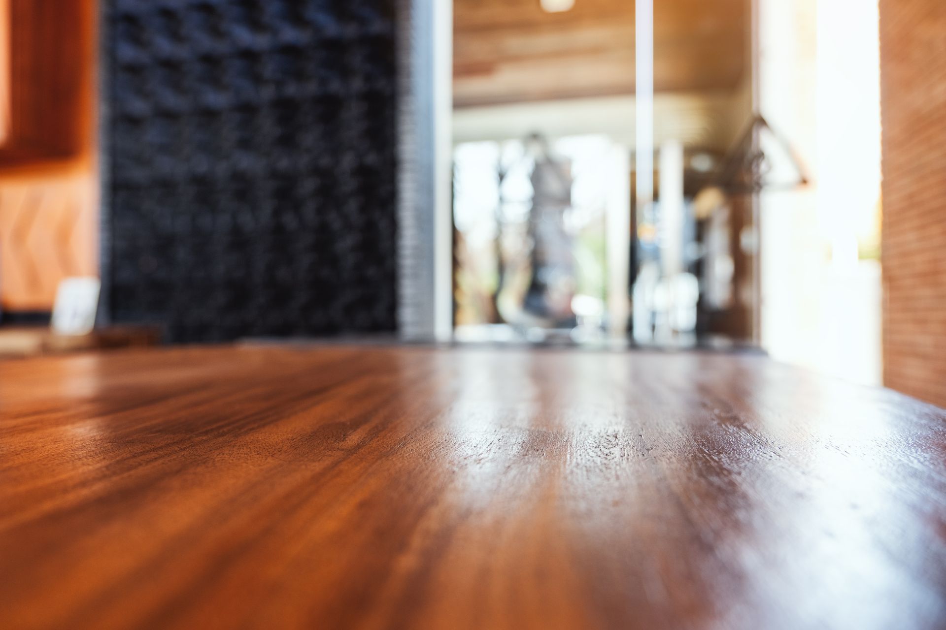 A wooden floor in a room with a blurred background.