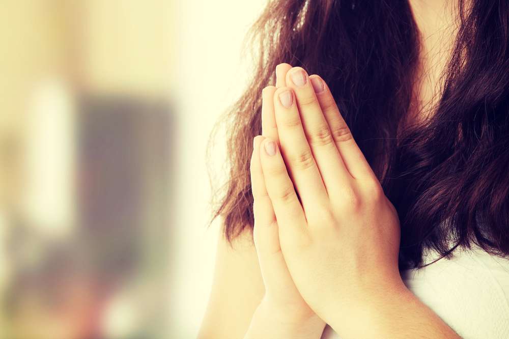 woman in a praying hands