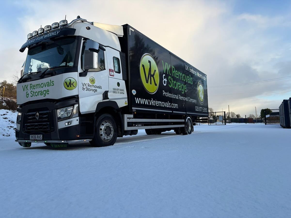 A large truck is parked in the snow.