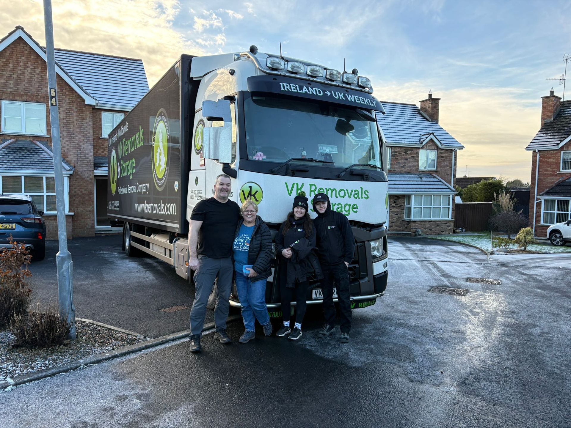 A group of people are standing in front of a large truck.