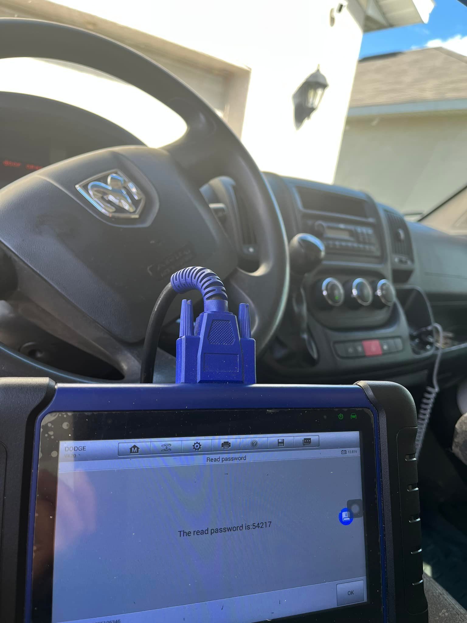 A diagnostic tool connected to a vehicle's dashboard, displaying an error message.