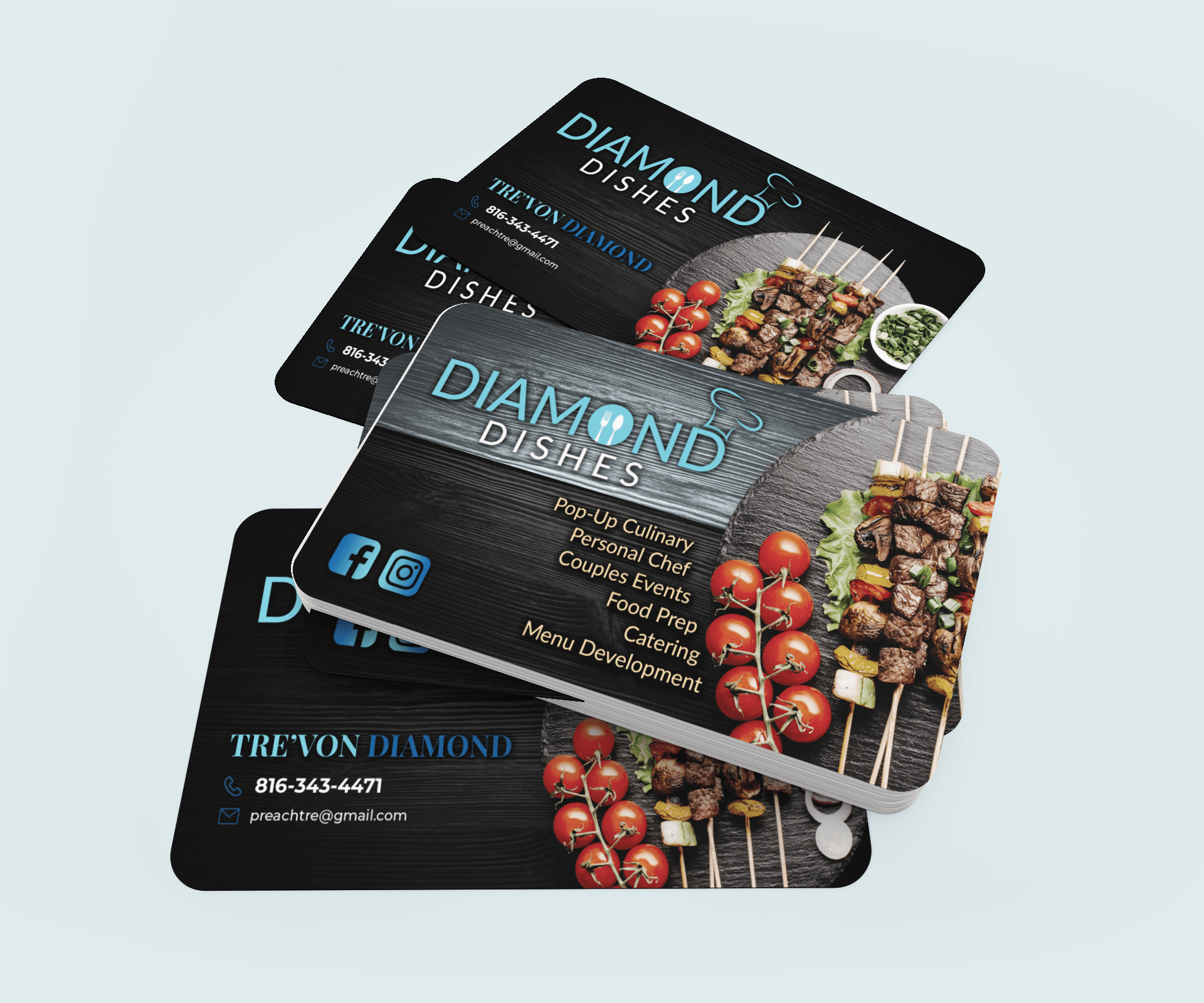 Three business cards are stacked on top of each other on a table.