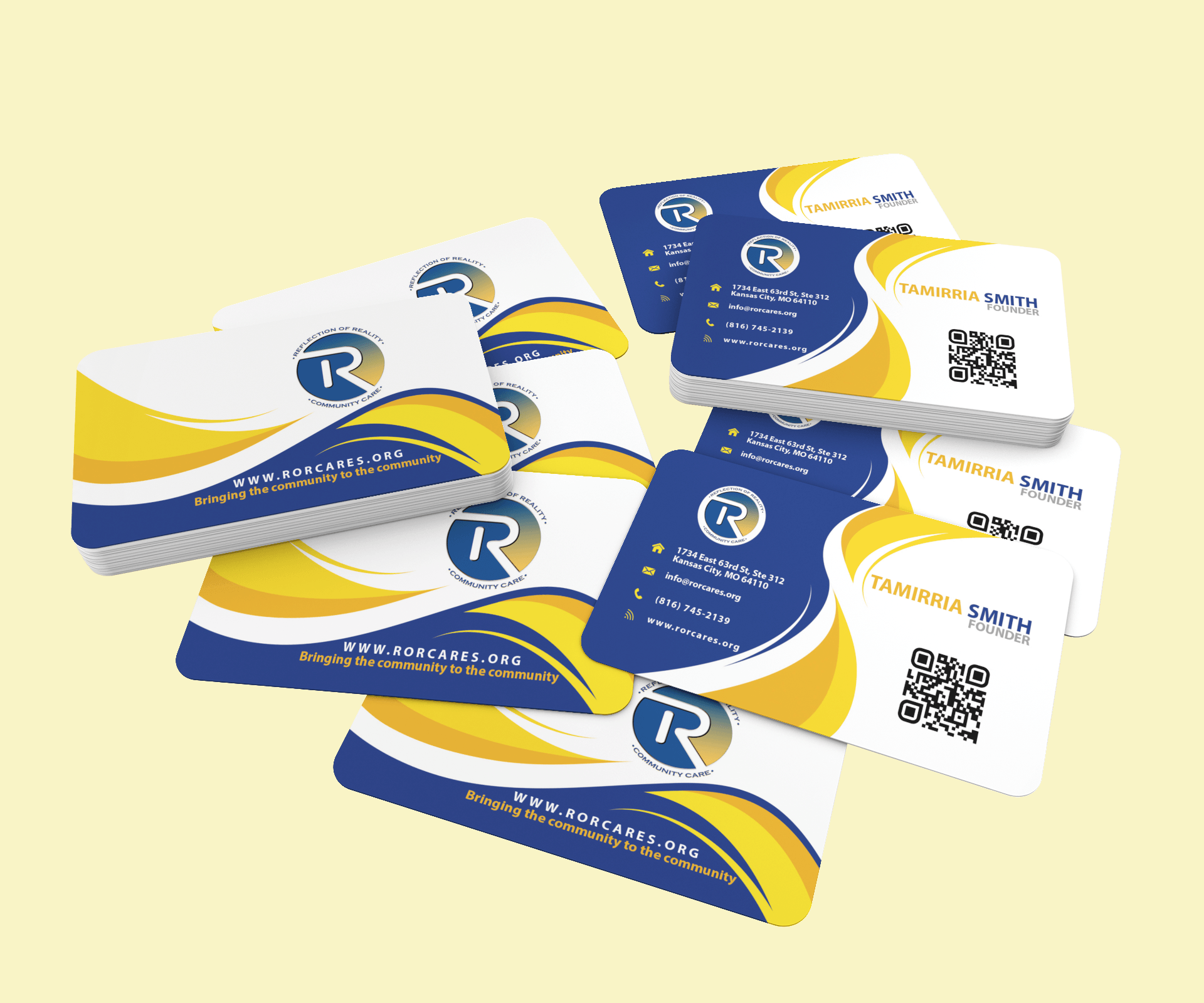 A bunch of business cards are stacked on top of each other on a yellow background.