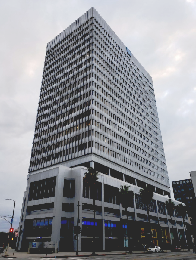 A man in a suit and tie sits in a conference room
