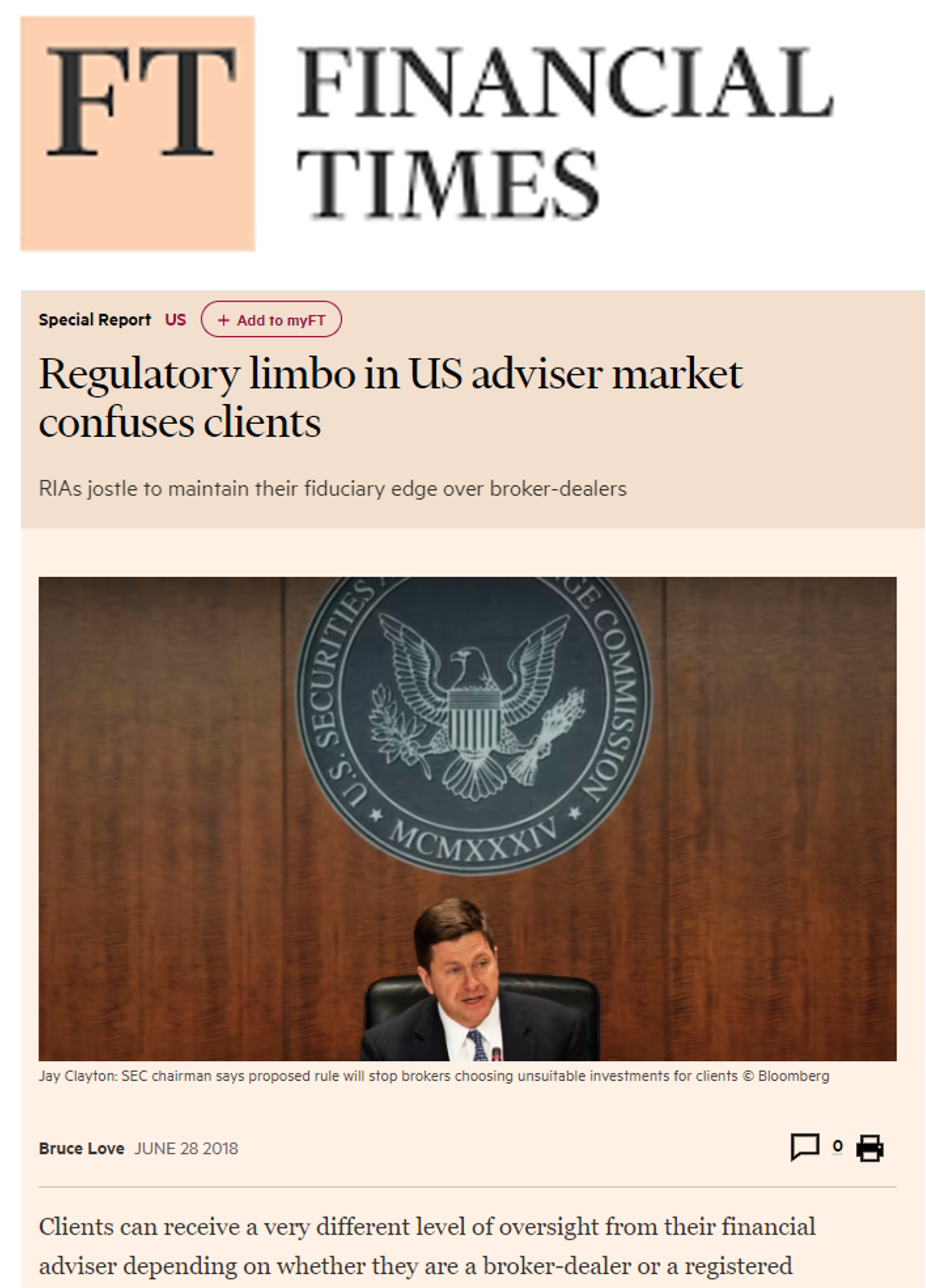 A man in a suit and tie is sitting in front of a wooden wall.