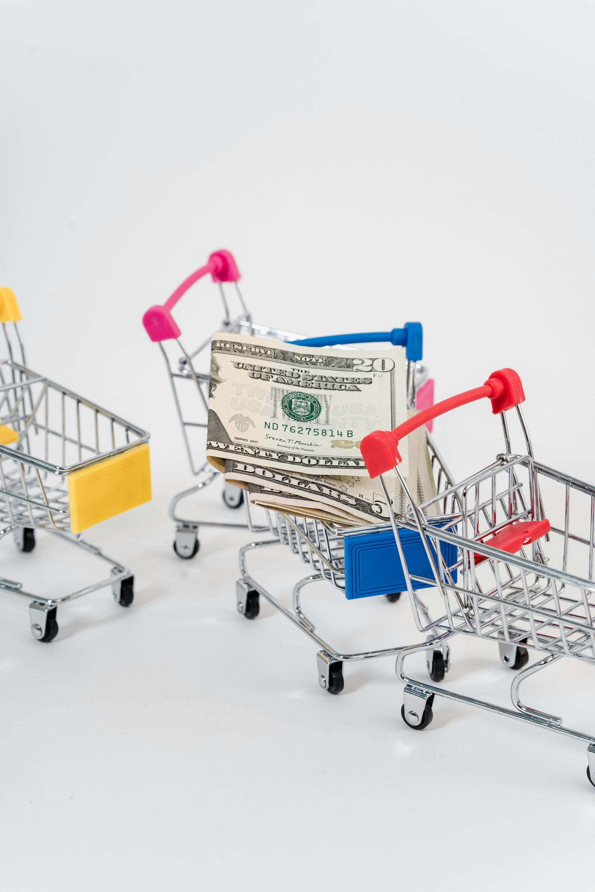 A shopping cart with a dollar bill in it.