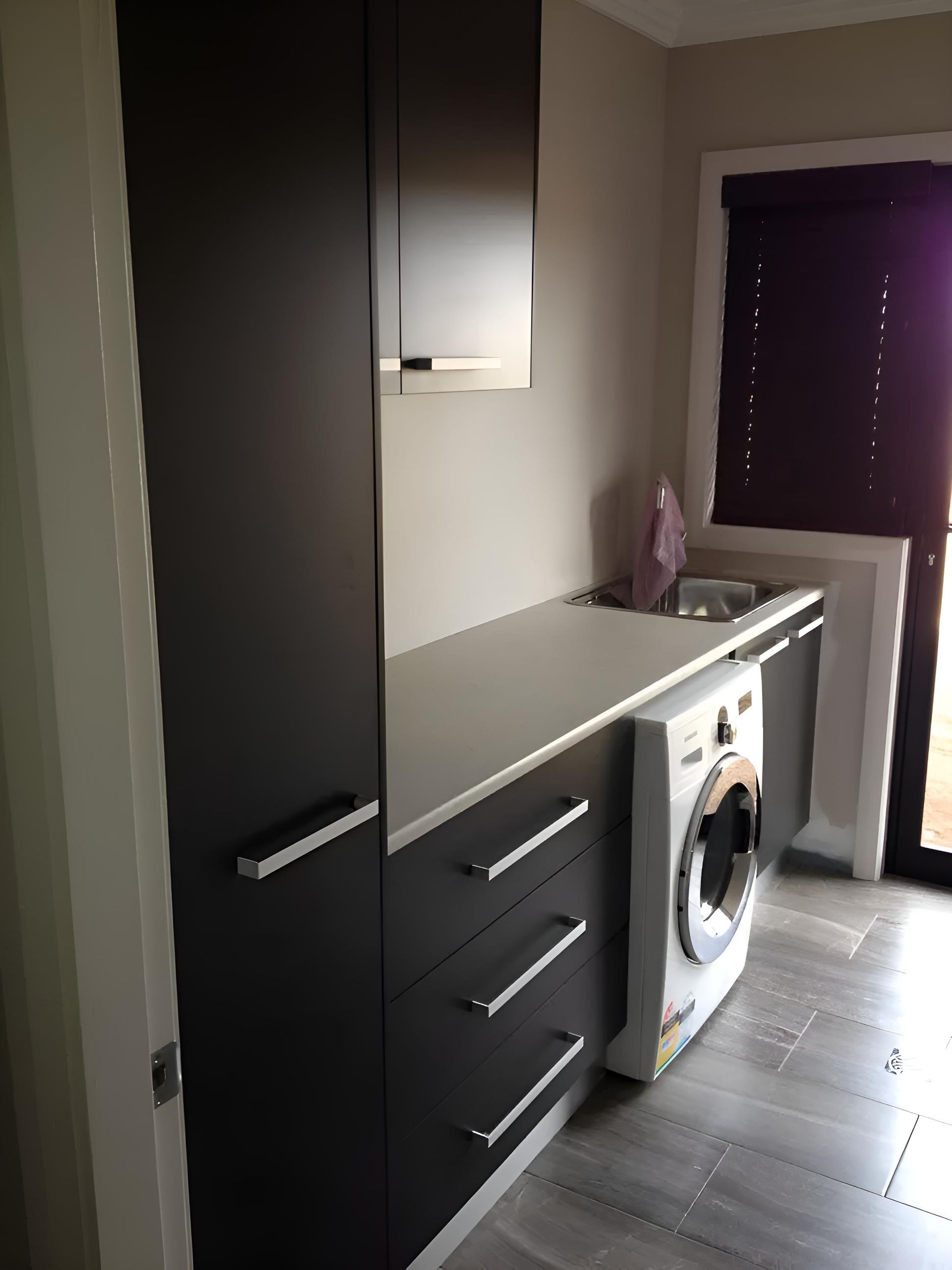 A Laundry Room With a Washing Machine and a Sink — Hey Presto Kitchens & Renovations in Armidale, NSW
