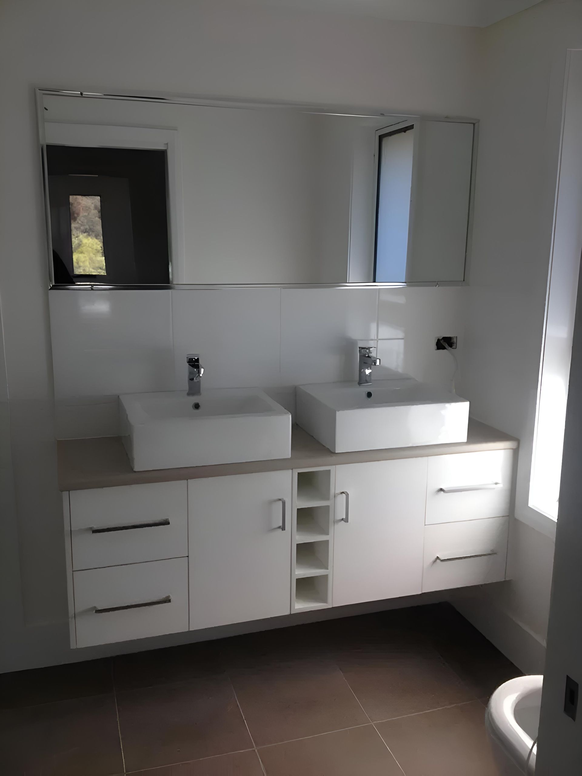 A Bathroom With Two Sinks and a Mirror — Hey Presto Kitchens & Renovations in Armidale, NSW