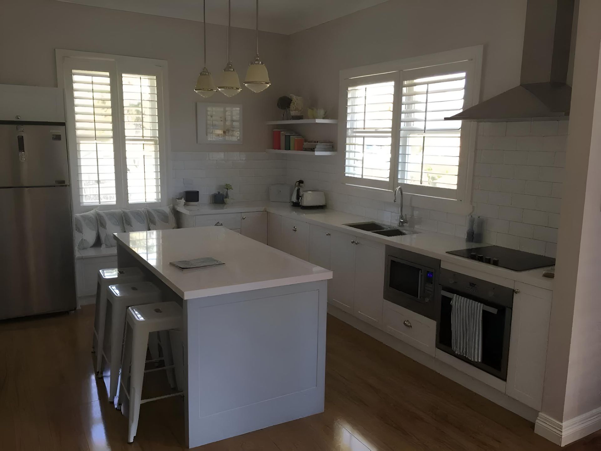 A Kitchen With A Large Island And Stools — Hey Presto Kitchens & Renovations in Guyra, NSW