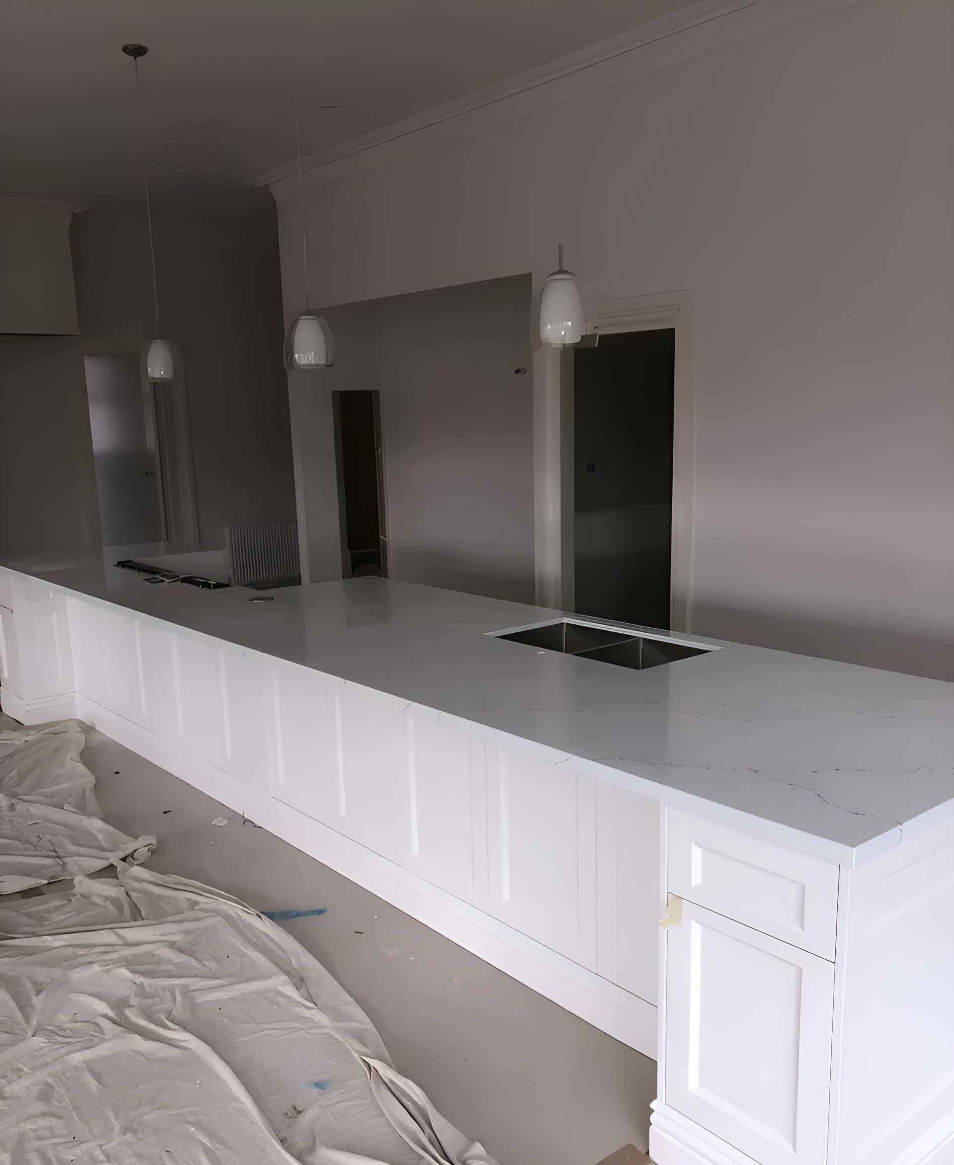 A Long White Counter in a Kitchen With a Sink — Hey Presto Kitchens & Renovations in Armidale, NSW