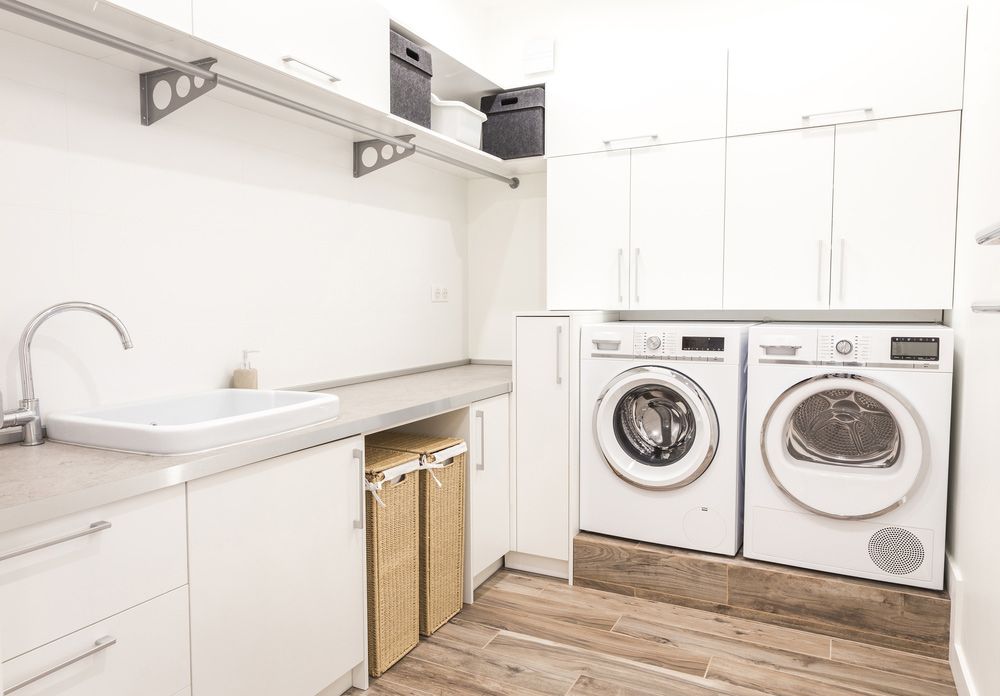 A Laundry Room With Two Washing Machines and a Sink — Hey Presto Kitchens & Renovations in Armidale, NSW
