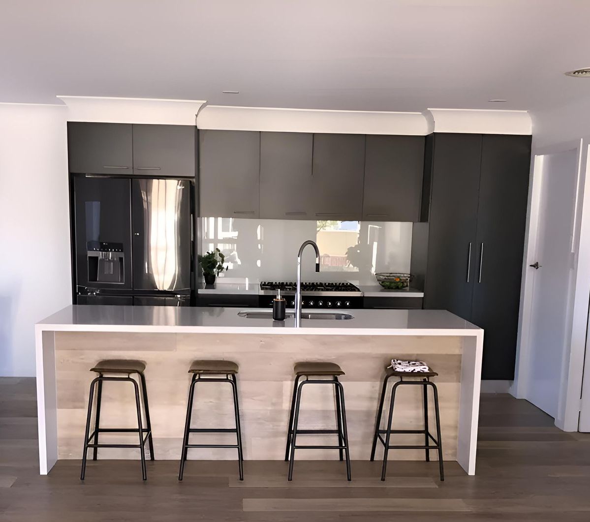 A Kitchen With a Large Island and Four Stools — Hey Presto Kitchens & Renovations in Armidale, NSW