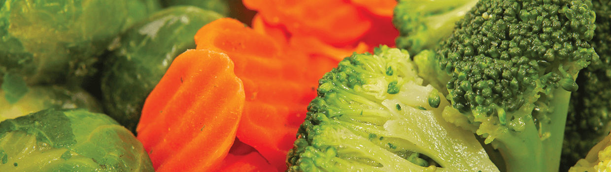 A close up of broccoli and carrots in a bowl.