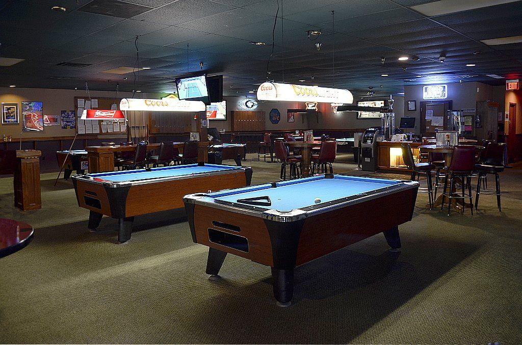 Interior of Side Pockets Lenexa filled with pool tables and table seating options.