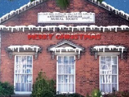 A brick building with a sign that says merry christmas