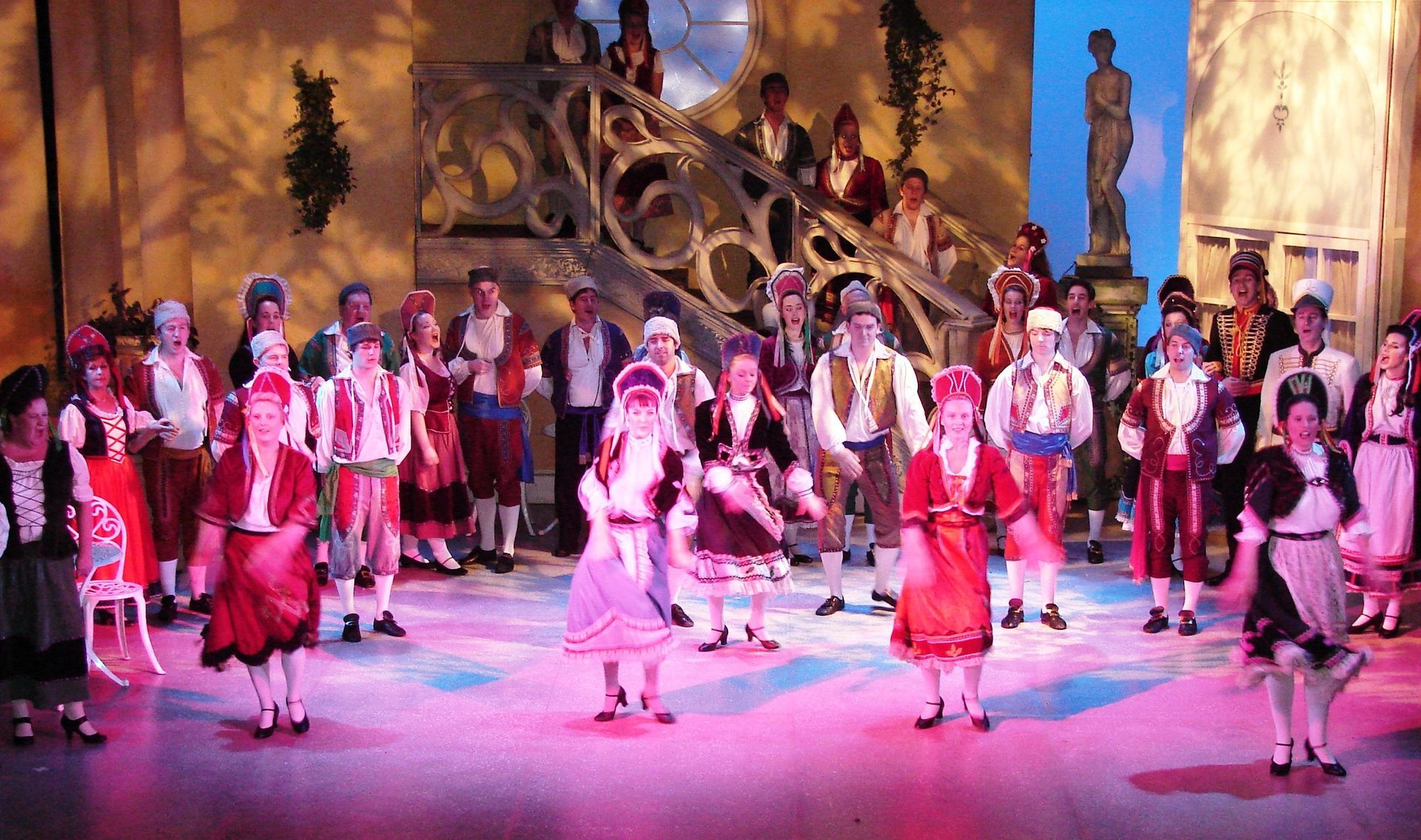 A large group of people are dancing on a stage.