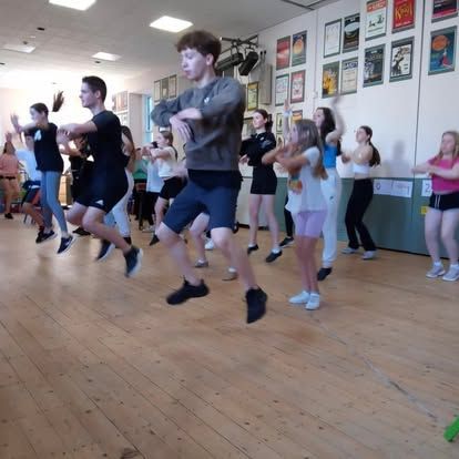 A group of people are dancing in a dance studio