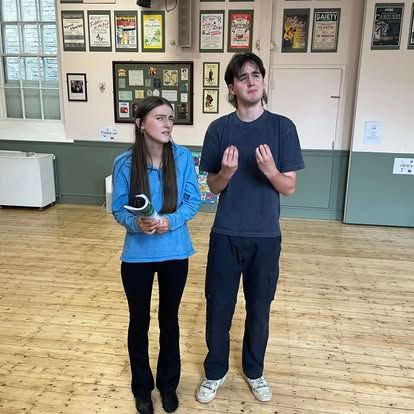 A man and a woman are standing next to each other in a room.