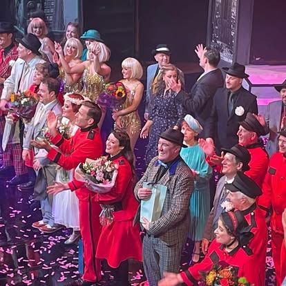 A large group of people are standing on a stage.