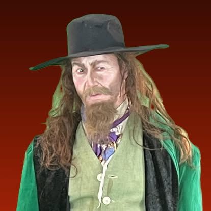 A man with long hair and a beard is wearing a hat and a green vest.