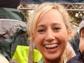 A bald man is smiling in a black and white photo.