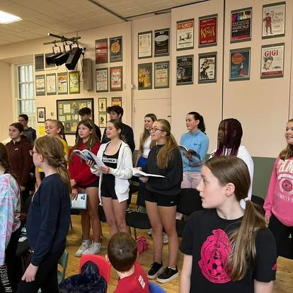 A group of young people are standing in a room.