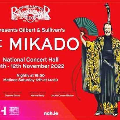 A poster for mikado shows a man in a kimono holding a fan