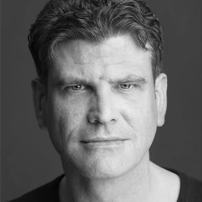 A close up of a man 's face in a black and white photo.