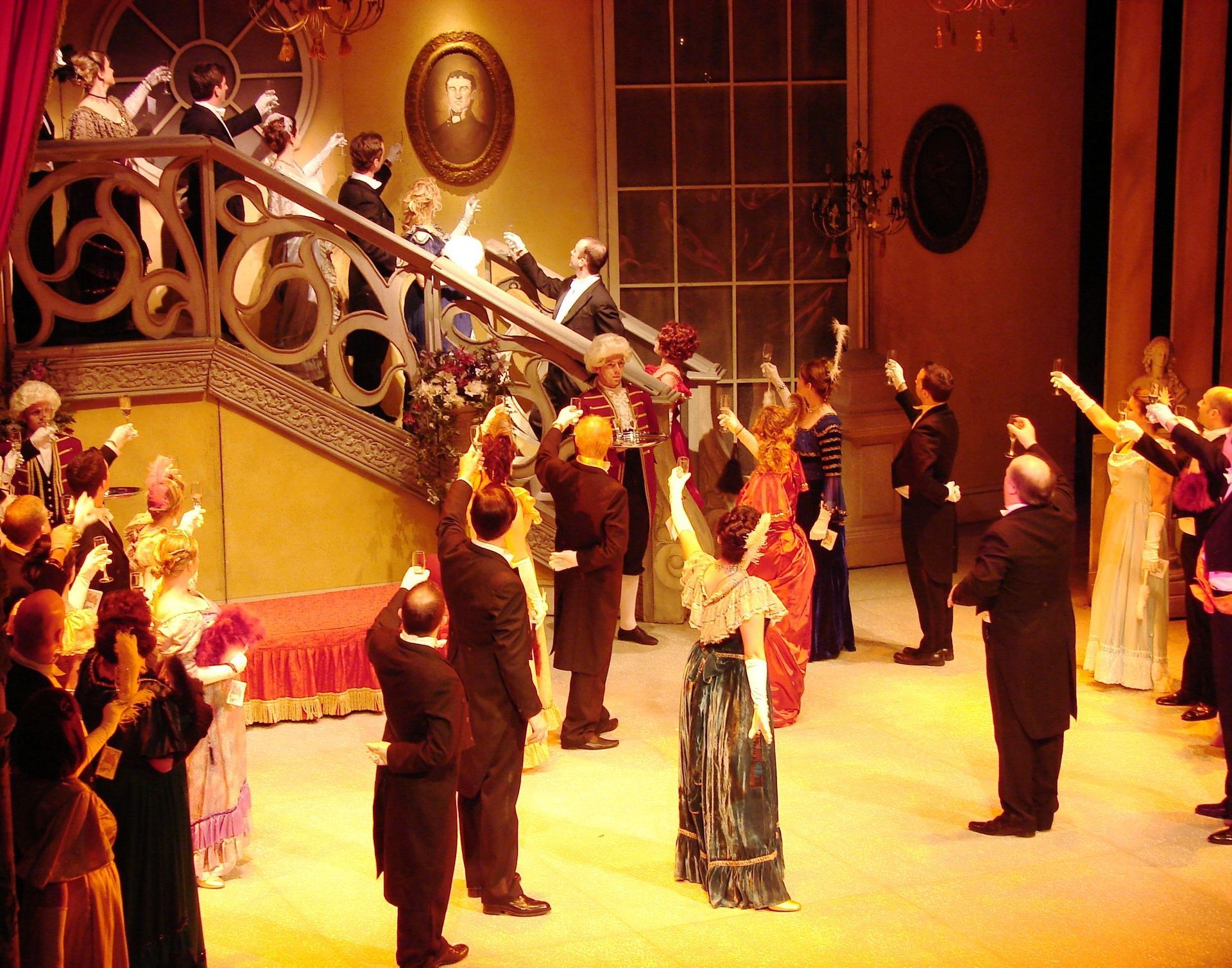 A group of people standing on a stage with their arms in the air