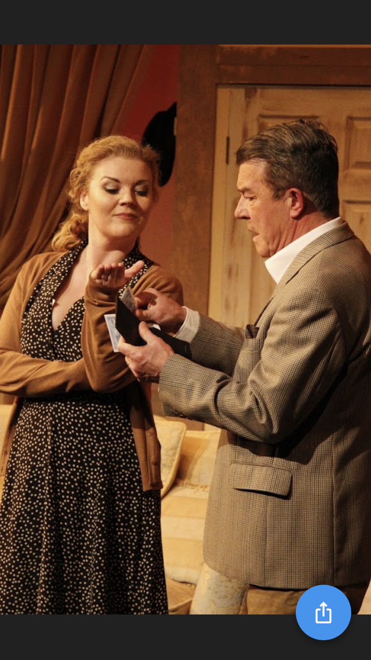 A man and a woman are standing next to each other on a stage.