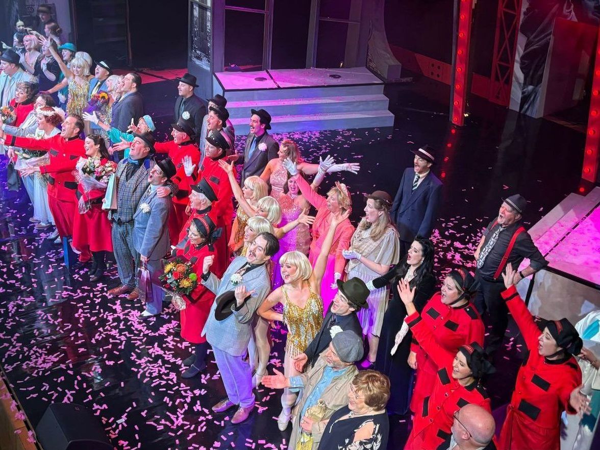 A large group of people are standing on a stage.