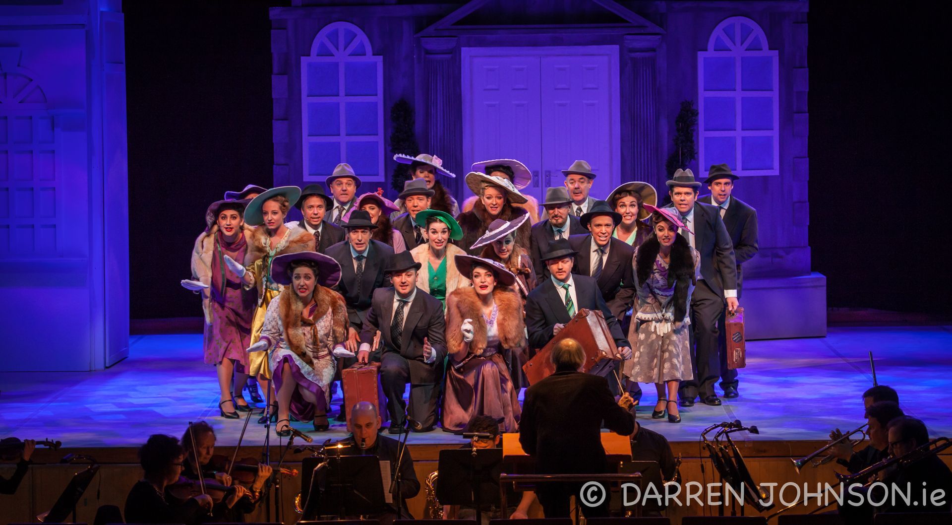 A group of people are posing for a picture on a stage.